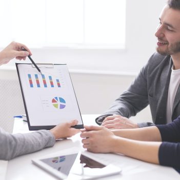 financial-advisor-showing-payments-plan-to-young-couple