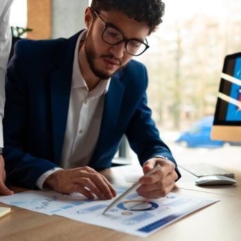 people-analyzing-checking-finance-graphs-office_23-2150377163